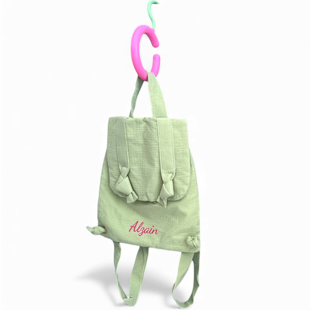 Green backpack with name 